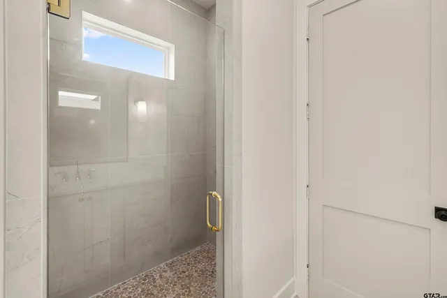 a bathroom with a glass shower door