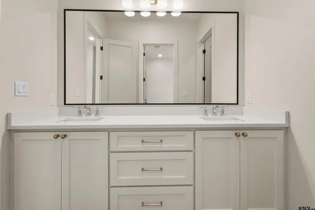 a white bath tub sitting next to a white sink and vanity