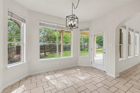 a view of an empty room with windows