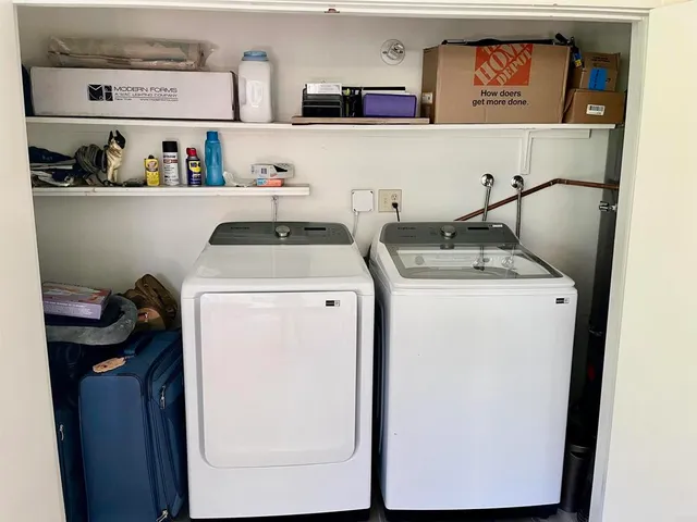 a utility room with closet dryer and washer
