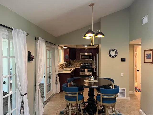 a dining room with furniture a chandelier and a rug