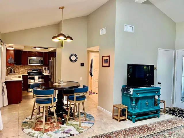 a view of a livingroom with furniture and a flat screen tv