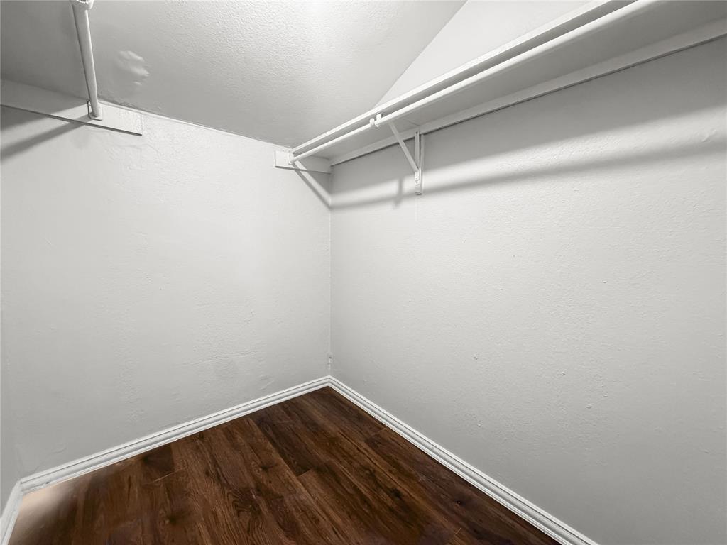 5840 Spring Valley Road, Unit 1104 Dallas, TX 75254 - Photo 5 of 16 Walk-in closet featuring wood-finish flooring, white baseboards, and white wire shelving with hanging rods