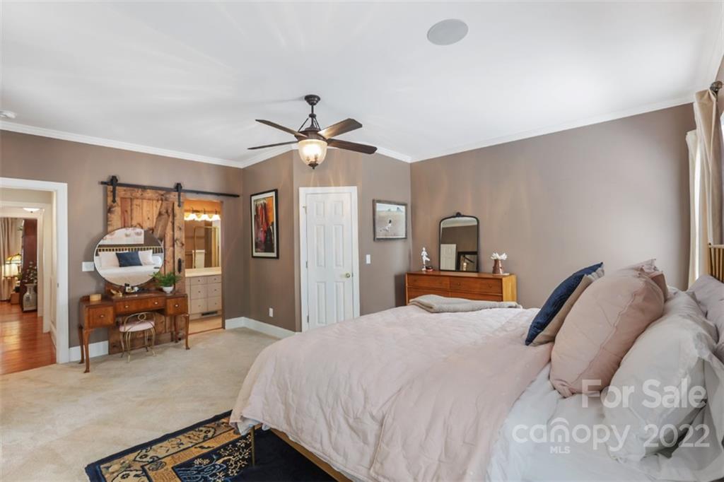 1023 Sedgefield Road Charlotte, NC 28209 - Photo 19 of 40 a bedroom with a bed and a chandelier