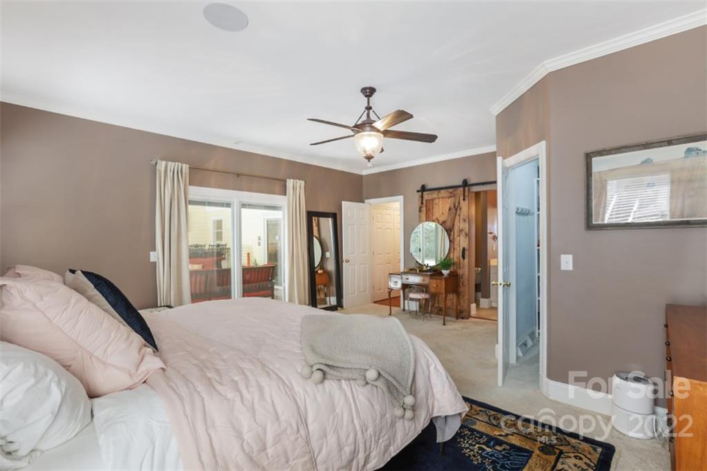 1023 Sedgefield Road Charlotte, NC 28209 - Photo 20 of 40 a bed room with a bed and a large mirror