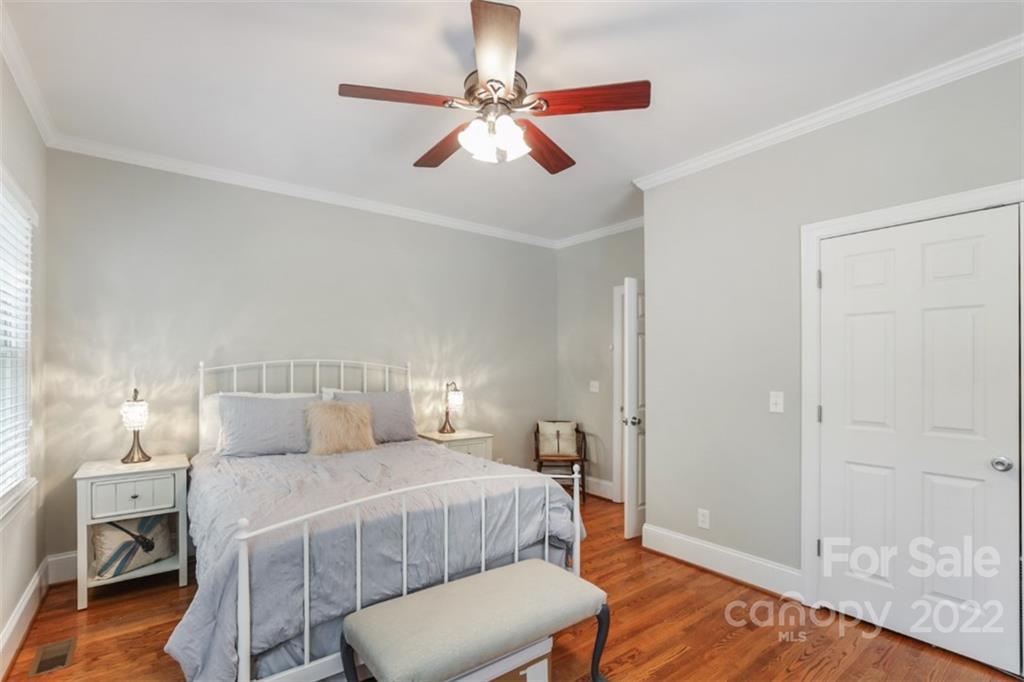 1023 Sedgefield Road Charlotte, NC 28209 - Photo 22 of 40 a bedroom with a bed and wooden floor