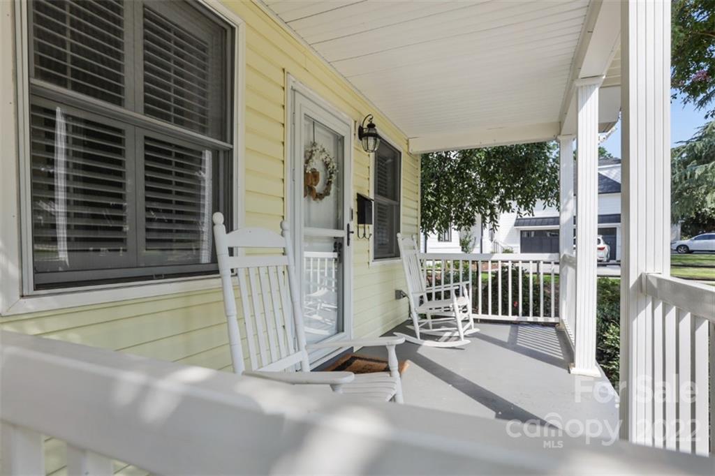 1023 Sedgefield Road Charlotte, NC 28209 - Photo 5 of 40 a view of a house with a floor to ceiling window and wooden fence