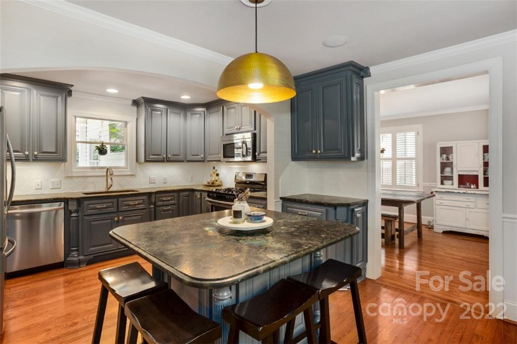1023 Sedgefield Road Charlotte, NC 28209 - Photo 9 of 40 a kitchen with a dining table chairs and microwave
