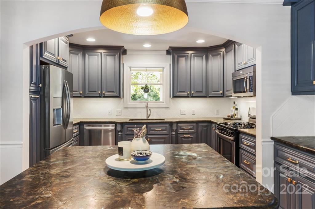 1023 Sedgefield Road Charlotte, NC 28209 - Photo 10 of 40 a kitchen with a refrigerator and stove