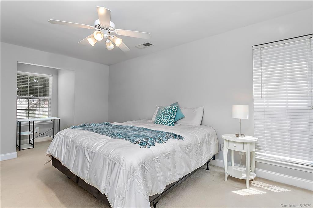 13011 Meadowmere Road Huntersville, NC 28078 - Photo 14 of 20 a bedroom with a bed and a chandelier