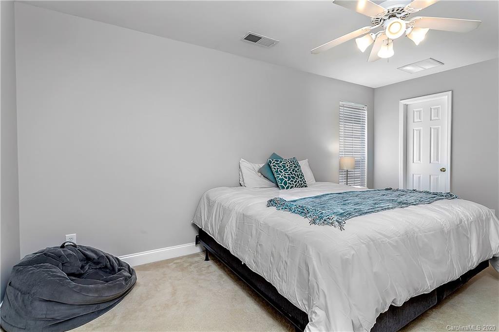 13011 Meadowmere Road Huntersville, NC 28078 - Photo 15 of 20 a bedroom with a bed and a chandelier