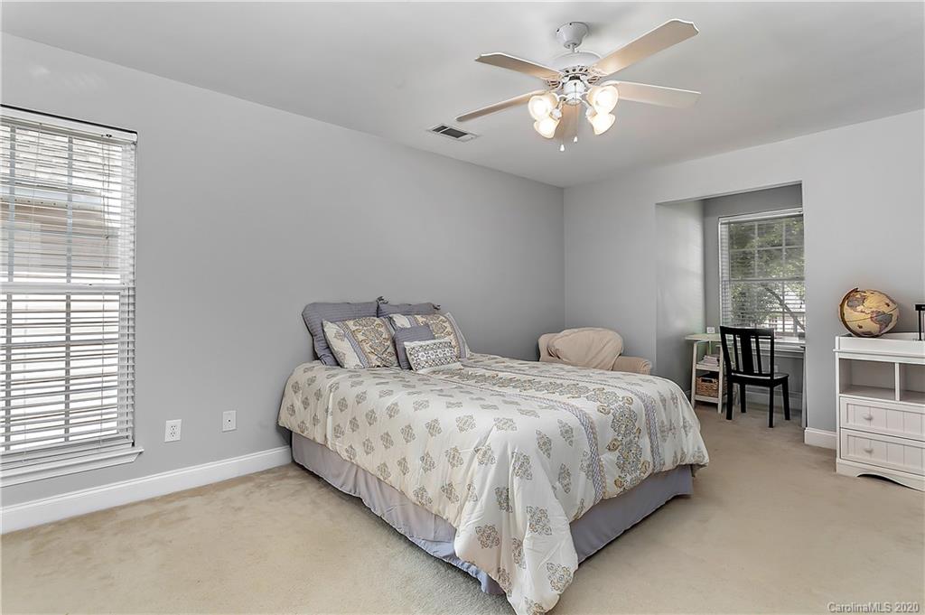 13011 Meadowmere Road Huntersville, NC 28078 - Photo 16 of 20 a bedroom with bed and a chandelier