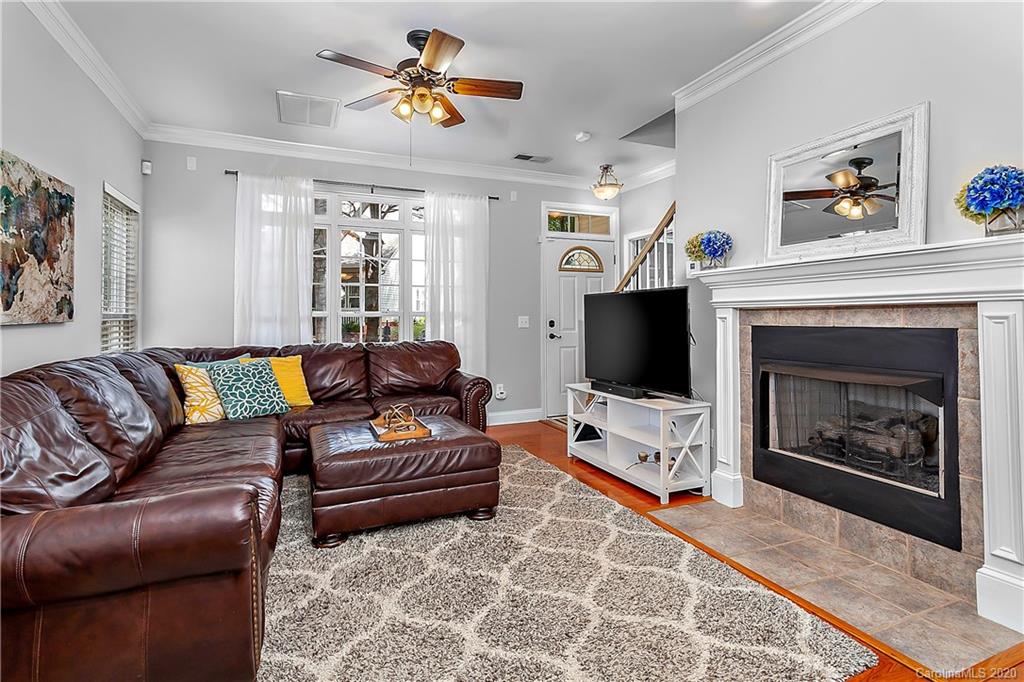 13011 Meadowmere Road Huntersville, NC 28078 - Photo 3 of 20 a living room with furniture a flat screen tv and a fireplace