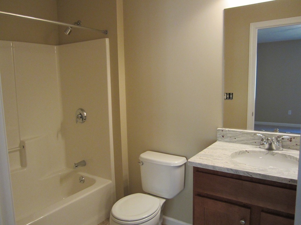 117 Dudley Road, Unit 117 Berlin, MA 01503 - Photo 14 of 21 a bathroom with a granite countertop sink toilet and shower