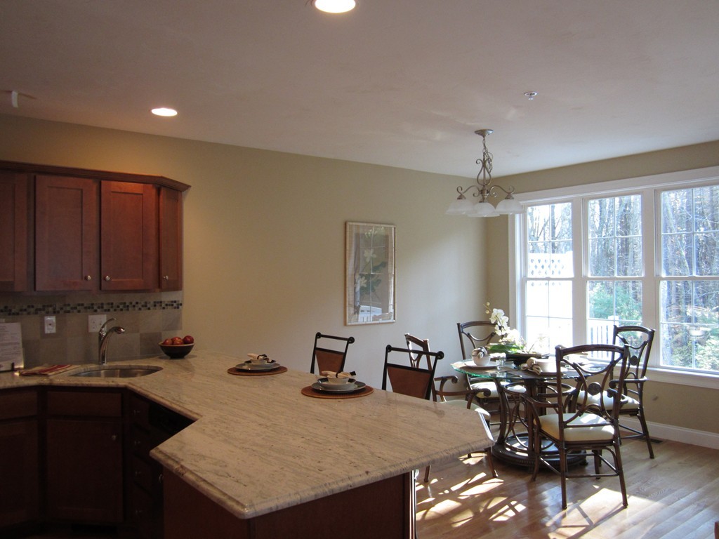 117 Dudley Road, Unit 117 Berlin, MA 01503 - Photo 4 of 21 a view of a dining room with furniture and wooden floor