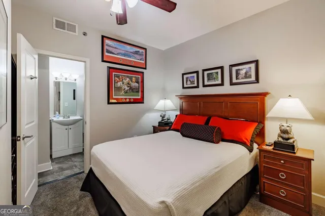 a bedroom with a bed and a lamp