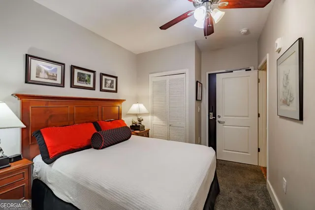 a bedroom with a large bed and a chandelier