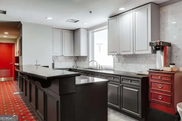 a kitchen with a sink stove and cabinets