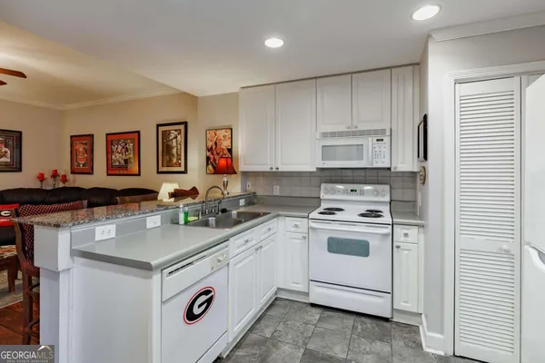 a kitchen with a stove a sink and a refrigerator