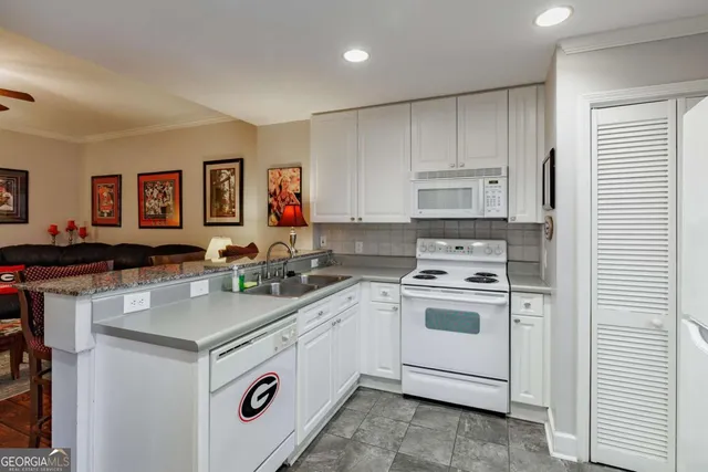 a kitchen with a stove a sink and a refrigerator