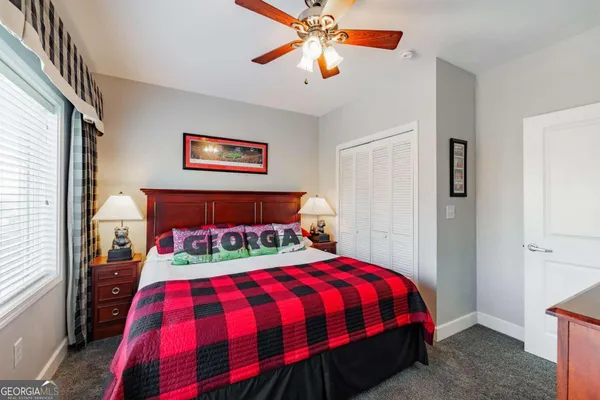 a bedroom with bed and a chandelier