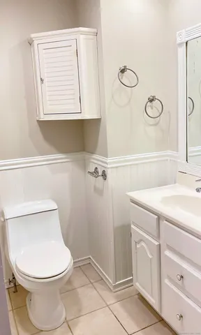 a white toilet sitting next to a bathroom sink