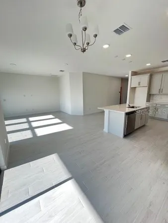 a view of kitchen with stainless steel appliances cabinets