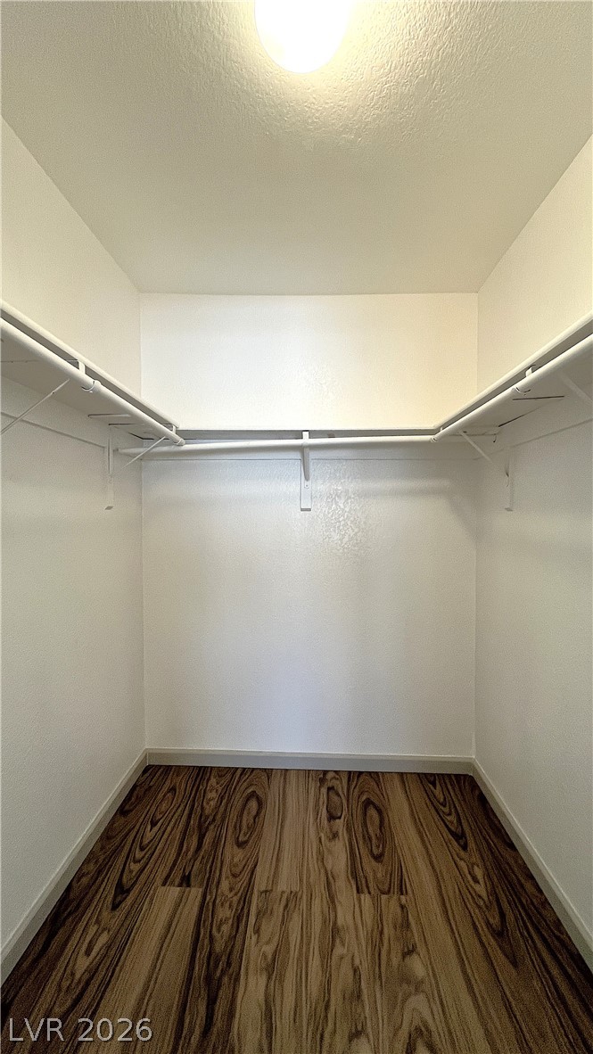 6750 Del Rey Avenue, Unit 123 Las Vegas, NV 89146 - Photo 18 of 21 A well-lit walk-in closet offers ample storage space and modern flooring.