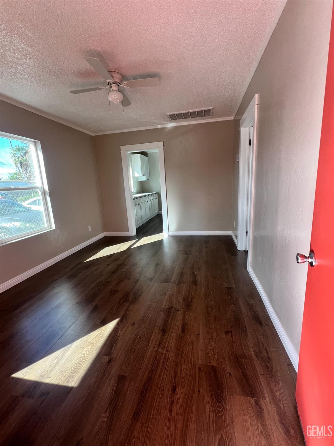 Undisclosed Address Bakersfield, CA 93304 - Photo 3 of 11 wooden floor in an empty room with a window