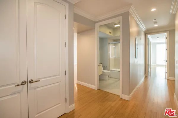 a view of a hallway with wooden floor
