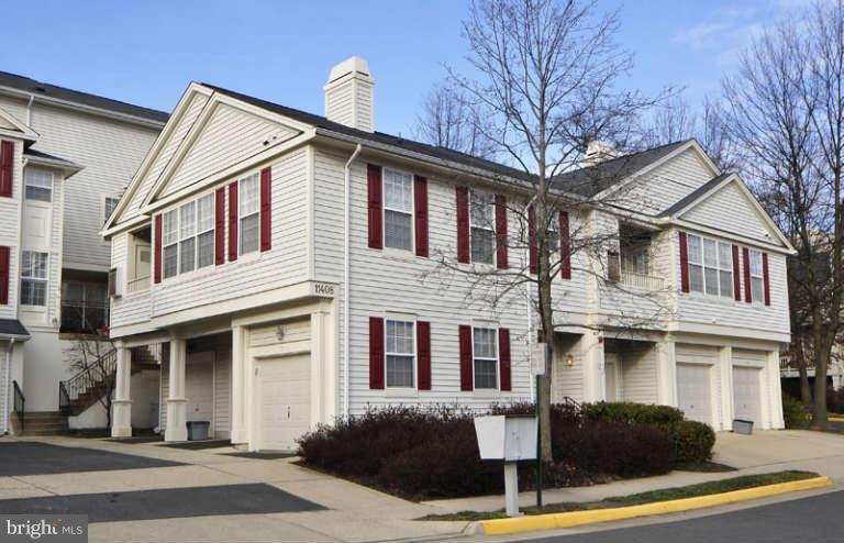 11408 Gate Hill Place, Unit O Reston, VA 20194 - Photo 2 of 30 a front view of a house with yard and parking