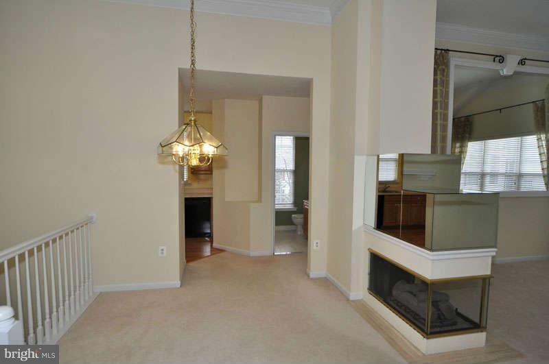 11408 Gate Hill Place, Unit O Reston, VA 20194 - Photo 5 of 30 a view of a hallway to a livingroom with furniture