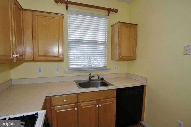11408 Gate Hill Place, Unit O Reston, VA 20194 - Photo 8 of 30 a kitchen with a sink cabinets and a window