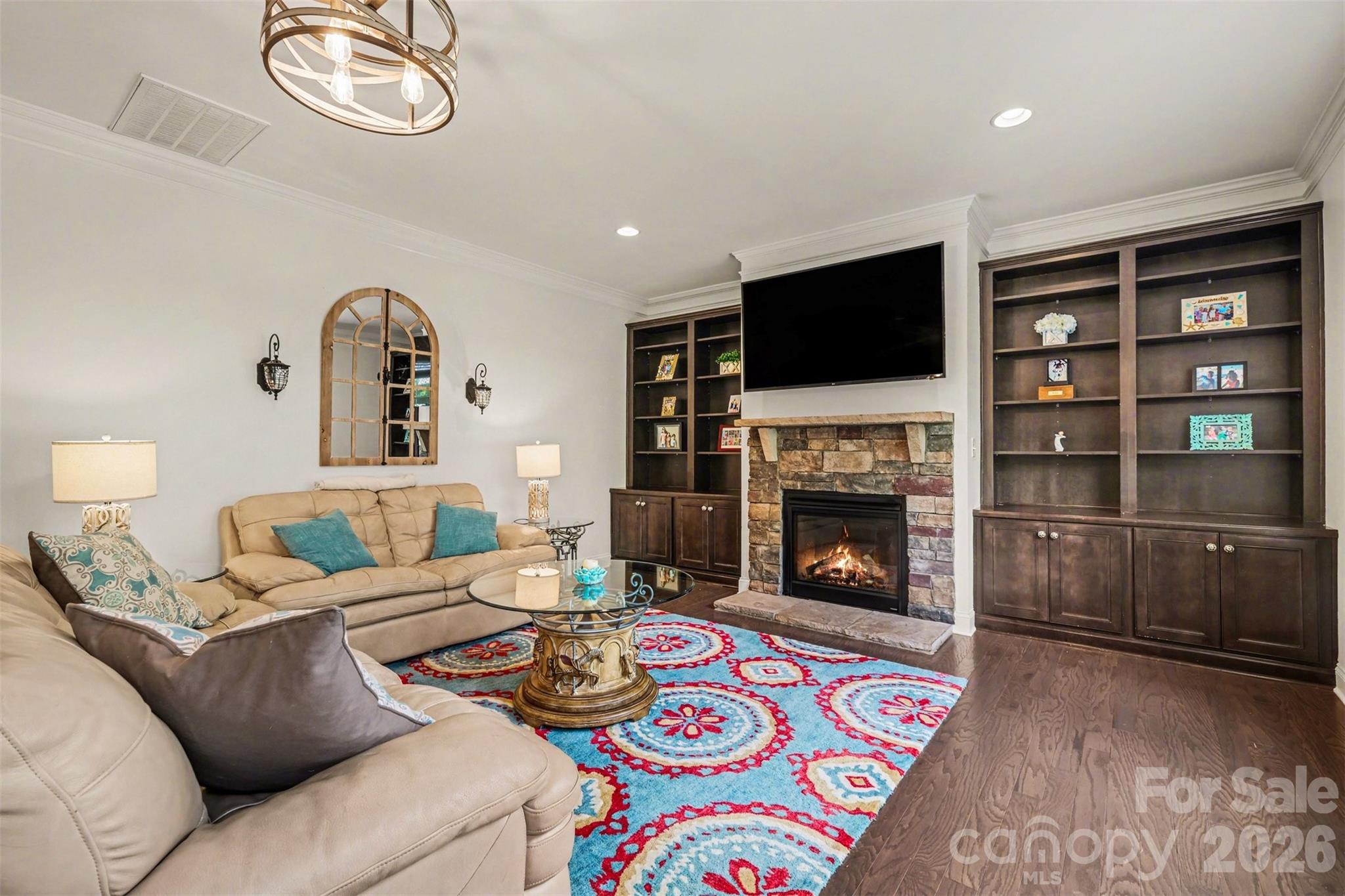 850 Coralbell Way Fort Mill, SC 29708 - Photo 12 of 48 a living room with furniture a flat screen tv and a fireplace