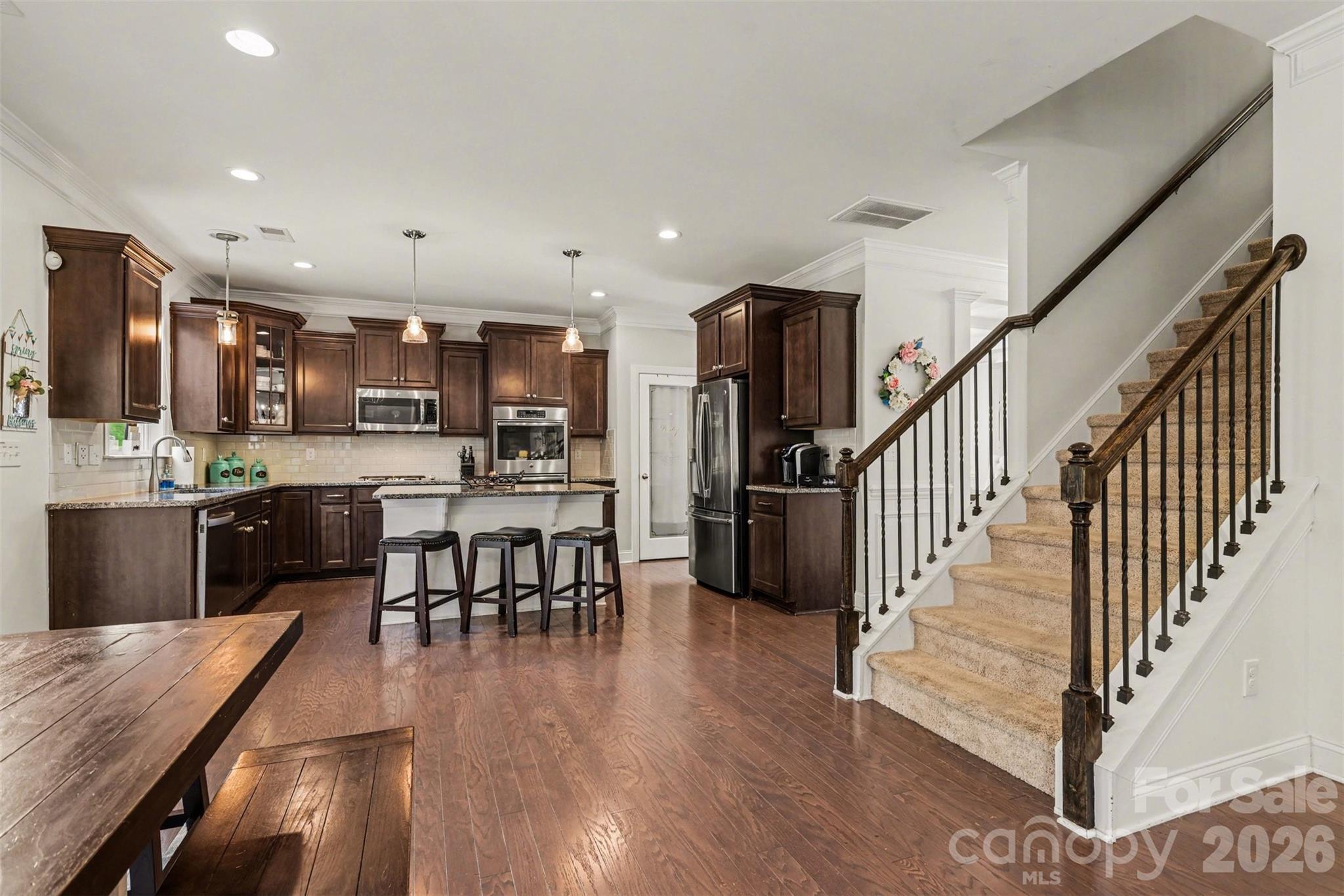 850 Coralbell Way Fort Mill, SC 29708 - Photo 15 of 48 a kitchen with a dining table chairs appliances and cabinets