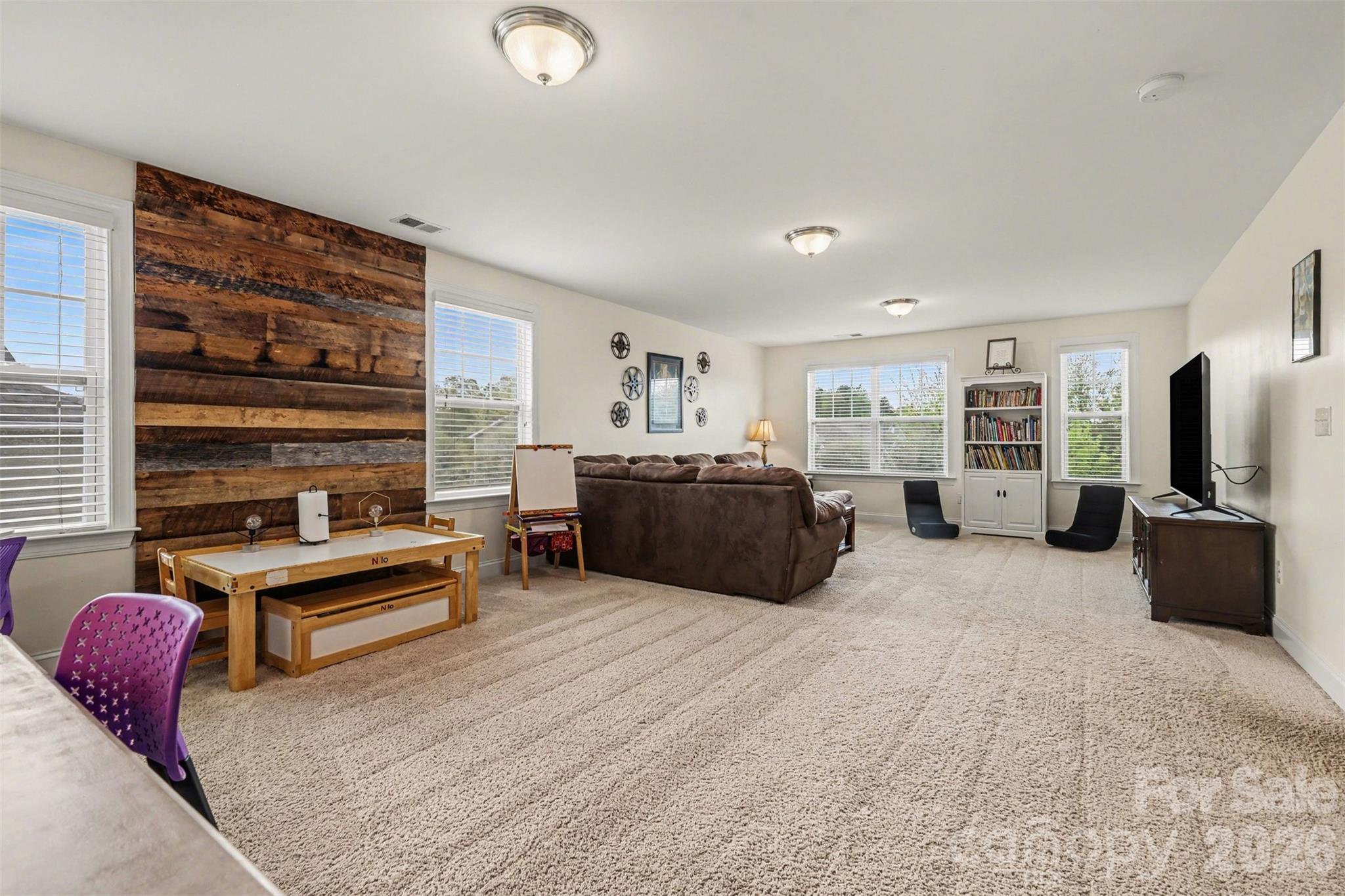 850 Coralbell Way Fort Mill, SC 29708 - Photo 20 of 48 a large bedroom with furniture and flat screen tv