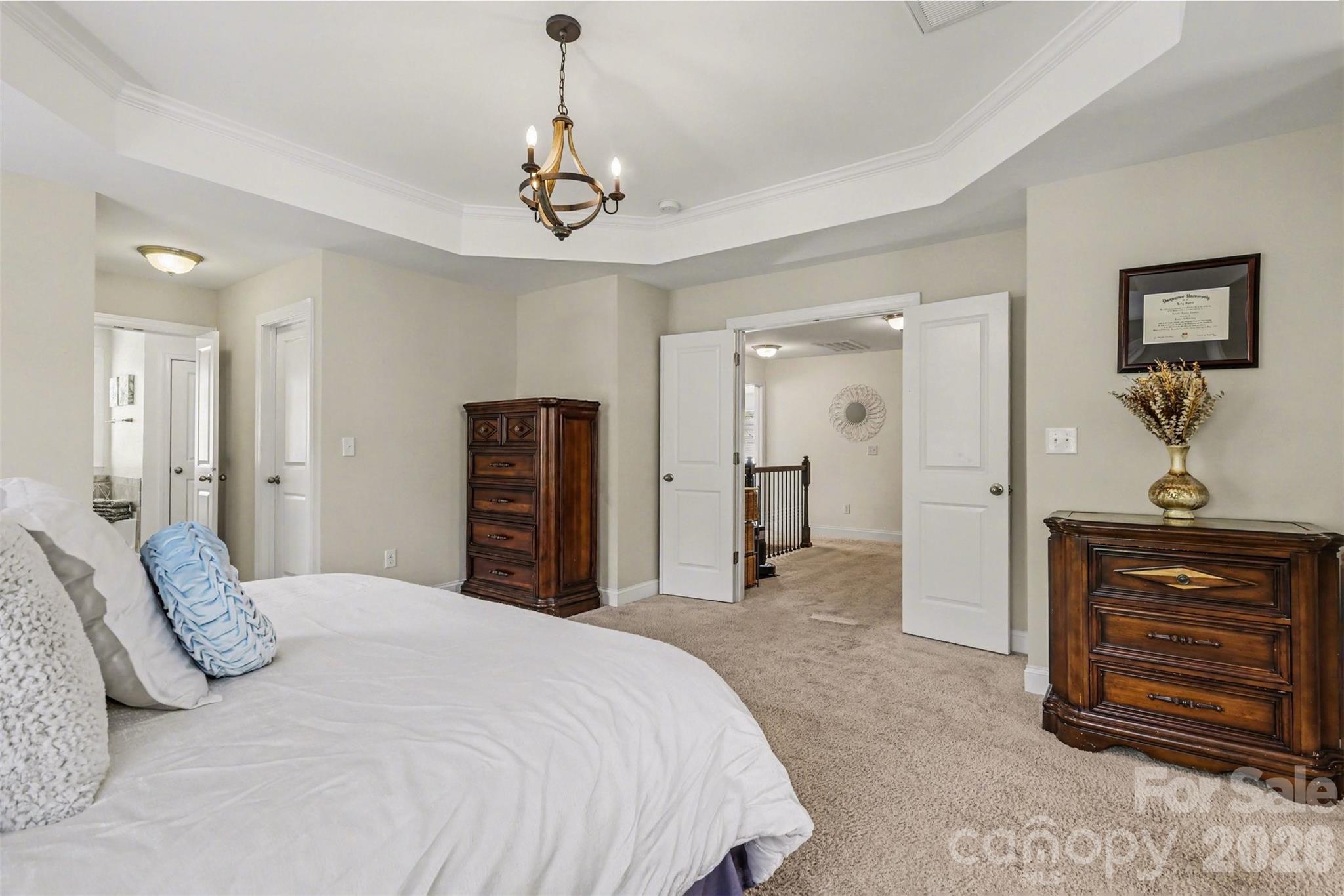850 Coralbell Way Fort Mill, SC 29708 - Photo 23 of 48 a bedroom with a bed and a chandelier