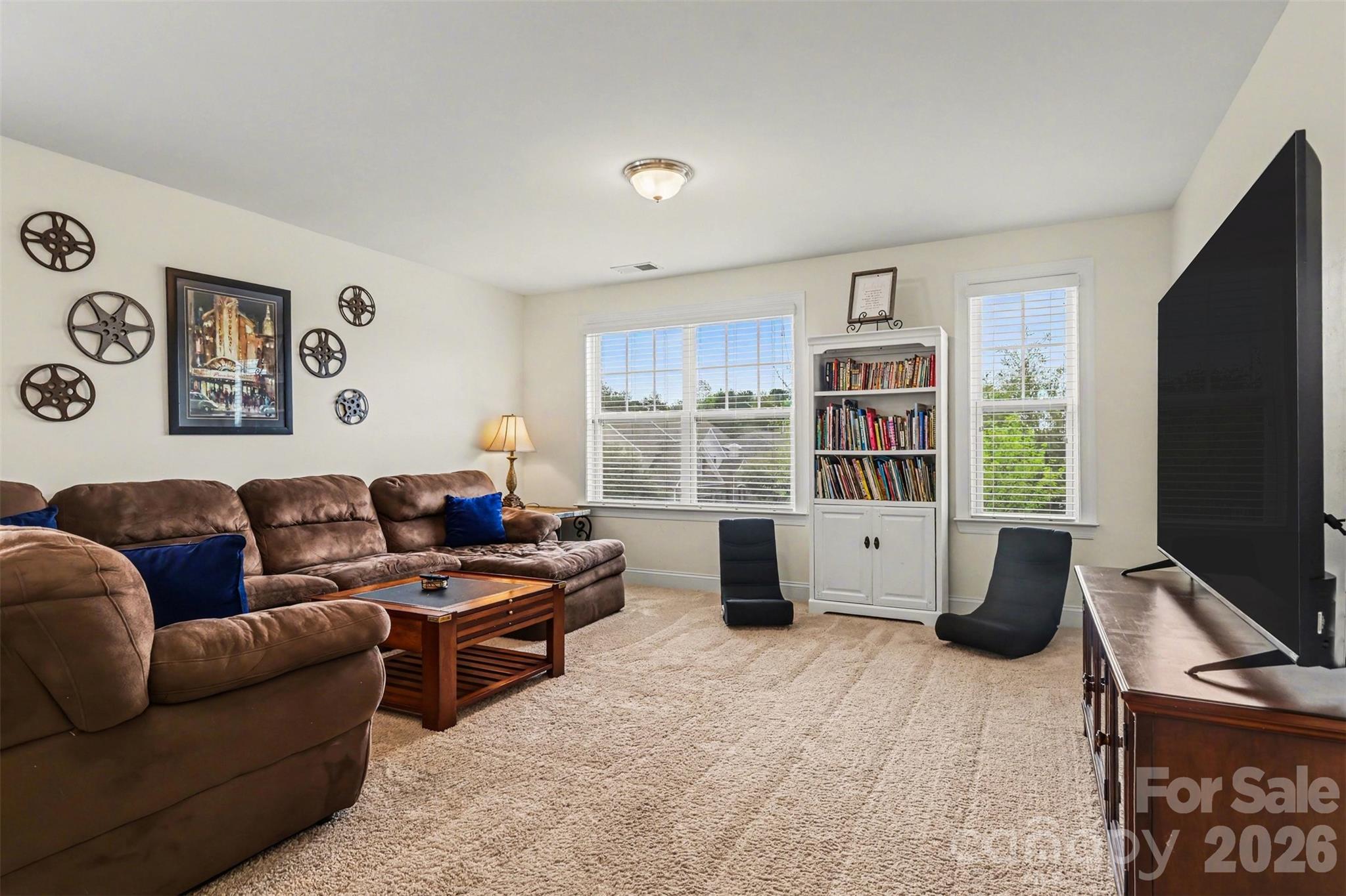 850 Coralbell Way Fort Mill, SC 29708 - Photo 27 of 44 a living room with furniture flat screen tv and a large window