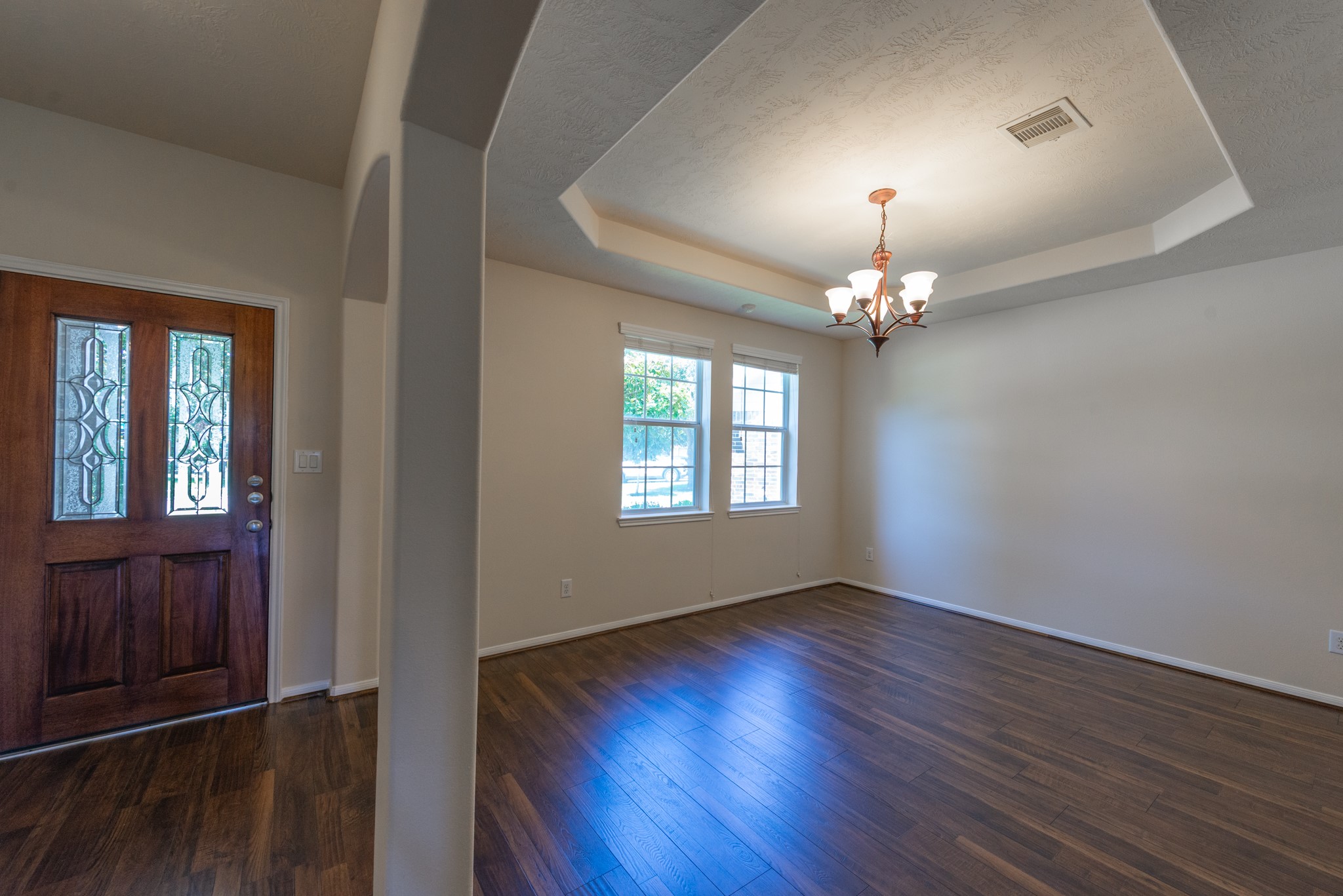 26302 Fox Ridge Lane Katy, TX 77494 - Photo 9 of 35 Elegant entryway with rich hardwood floors, opens to formal dining room. a charming chandelier illuminating the space.