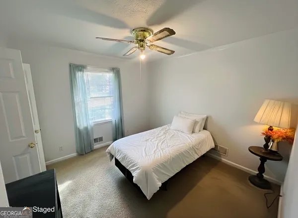 a bedroom with a bed window and couch