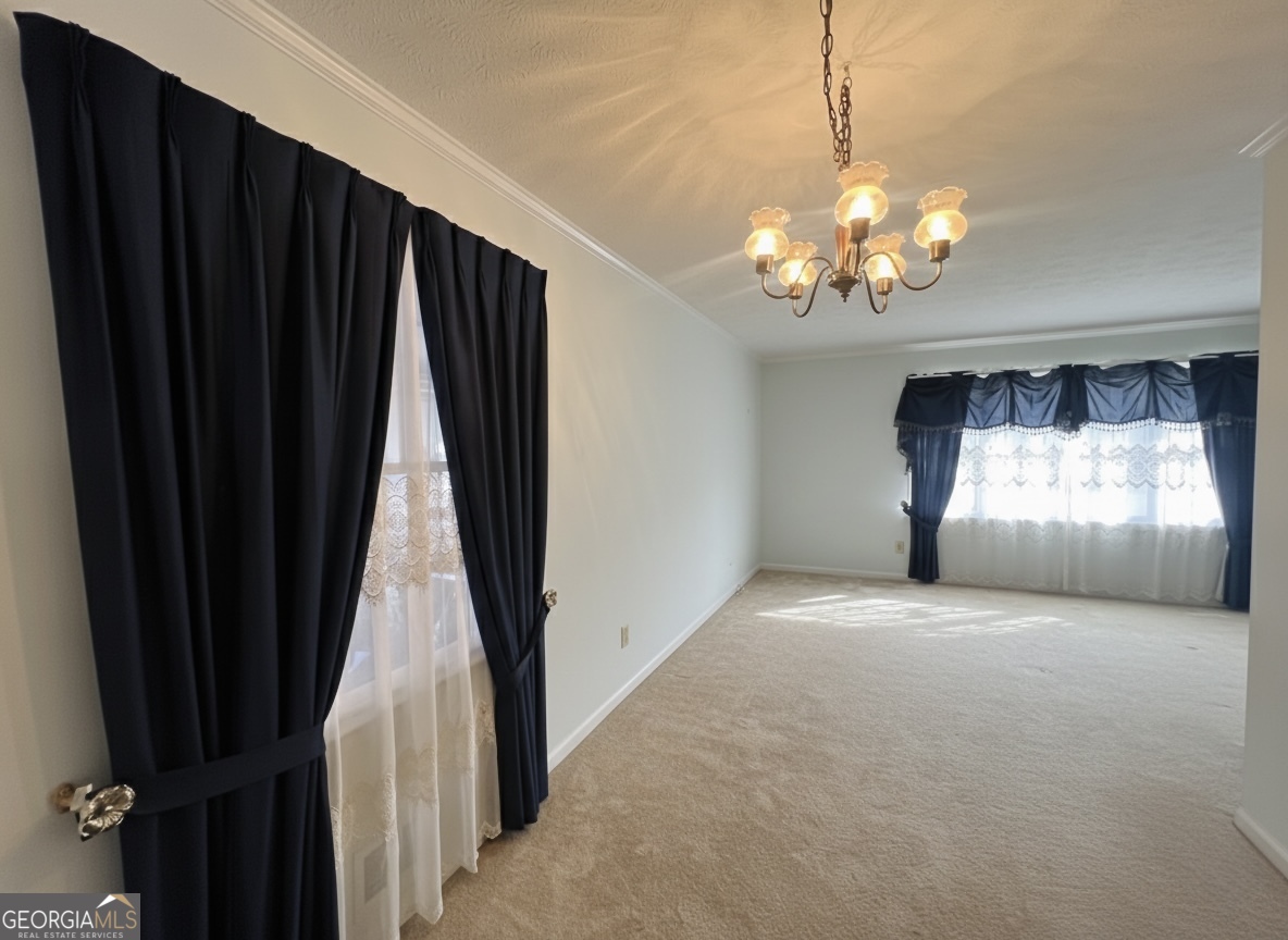 211 Clark Road Griffin, GA 30224 - Photo 12 of 25 a view of a livingroom with a chandelier