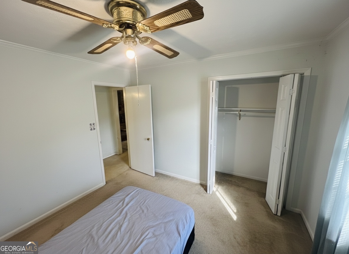 211 Clark Road Griffin, GA 30224 - Photo 15 of 25 a bedroom with a bed and a chandelier