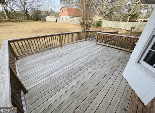 a view of a house with wooden deck