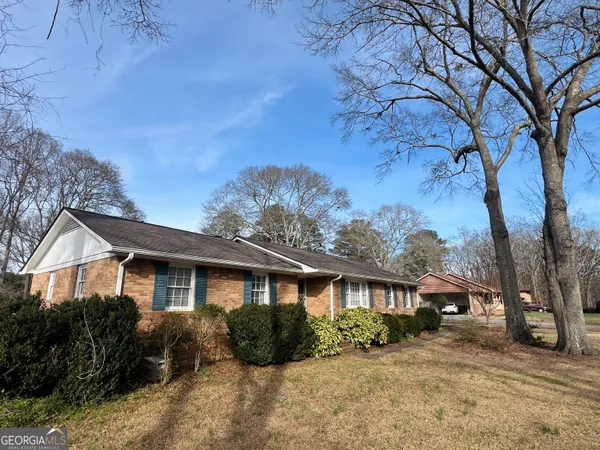 a front view of a house with a yard covered in snow