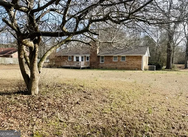 a view of yard with tree and wooden fence