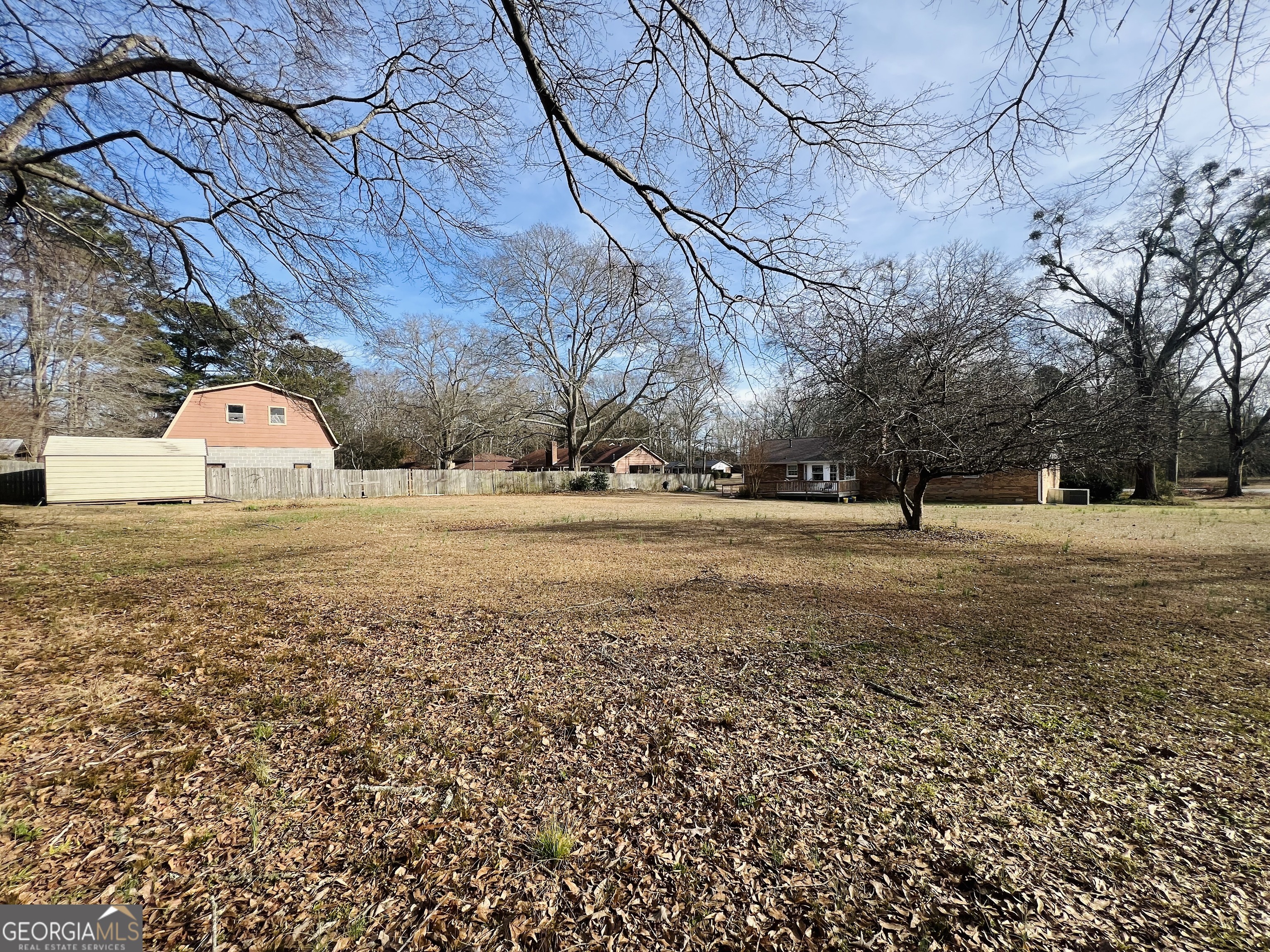211 Clark Road Griffin, GA 30224 - Photo 22 of 25 a view of yard with tree and wooden fence