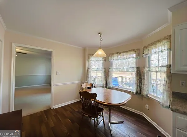 a view of a dining room with furniture window and wooden floor
