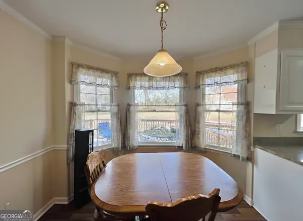 a dining room with furniture window and wooden floor