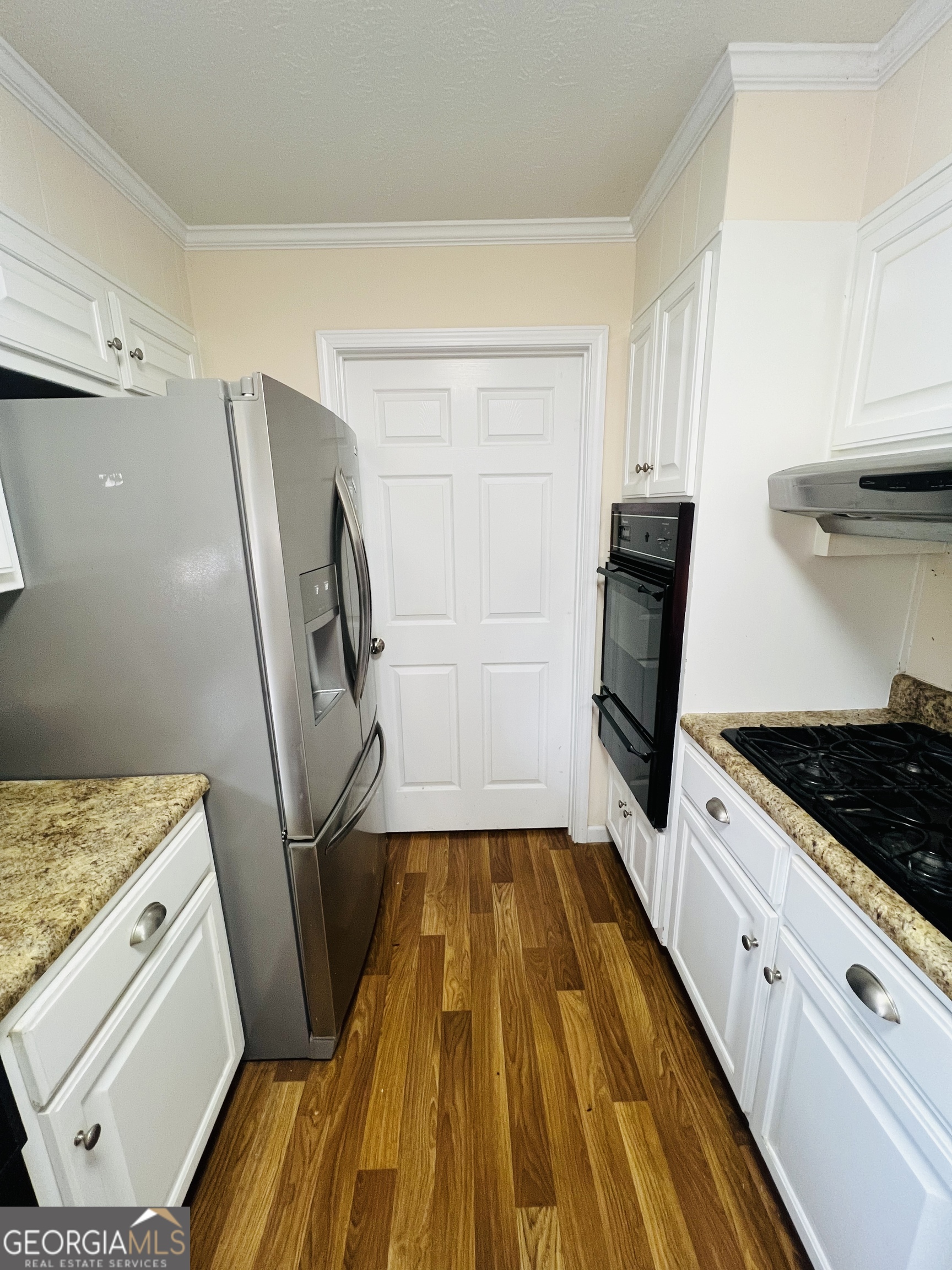 211 Clark Road Griffin, GA 30224 - Photo 9 of 25 a kitchen with white cabinets and appliances