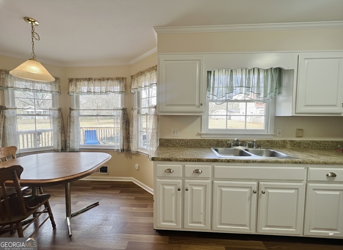 211 Clark Road Griffin, GA 30224 - Photo 10 of 25 a kitchen with granite countertop a sink cabinets and wooden floor